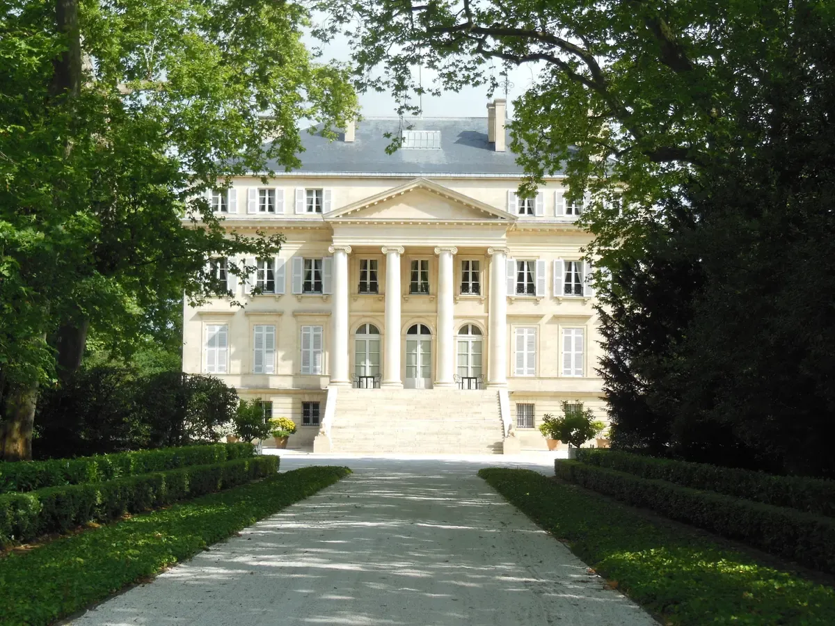 The front of Château Margaux at the end of its avenue, seen on a Bordeaux wine day tour
